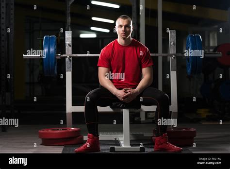 Portrait Of Muscular Powerlifter Bodybuilder Fitness Model Sitting