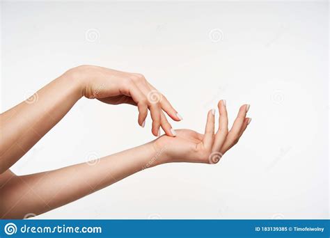 Indoor Shot Of Young Attractive Female`s Raised Hand Touching Gently