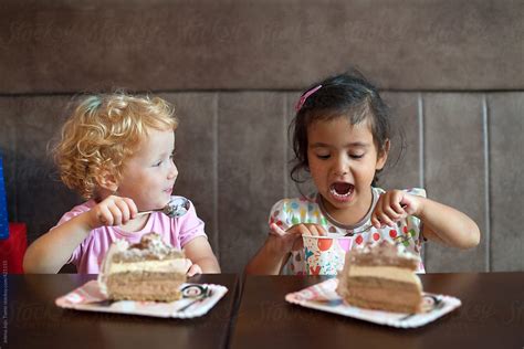 Little Girls Eat A Birthday Cake By Stocksy Contributor Jelena Jojic