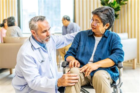 Orthopedist Examines The Knee Of Elderly Patient To Collect Information