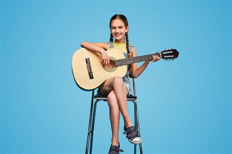 Girl Sitting On Chair And Playing Guitar Stock Image Image Of Melody Instrument 251051481