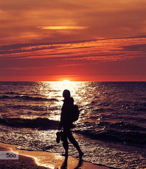 Woman Walking On The Beach At Sunset Sunset Beach Walk Beach Photos