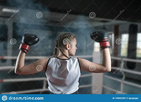 Young Girl Raised Her Hands In Boxing Gloves On The Sports Ring In A