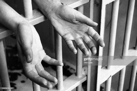 Hands In Prison Cell High Res Stock Photo Getty Images