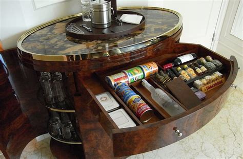 With no experience at all, this guy decides to transform a set of shelf speakers into a clever hiding bookshelf speaker liquor cabinet: DIY Liquor Cabinet for your Home - SirMixABot