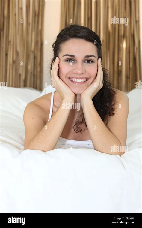 Brunette Woman Lying In Bed Stock Photo Alamy