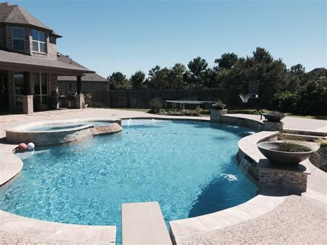 Freeform Travertine Pool With Raised Beam Wall Firepit Classico
