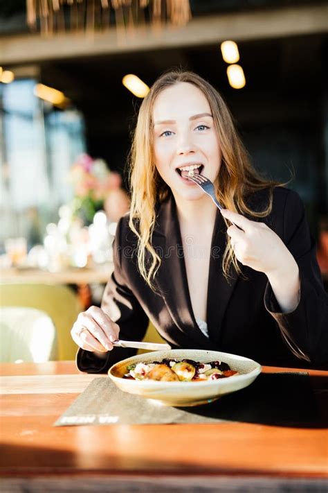 Young Beauty Woman Eating Healthy Food Sitting In The Beautiful Stock