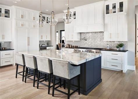 Maybe you would like to learn more about one of these? Polished white kitchen with gray wall tiles, dark blue ...