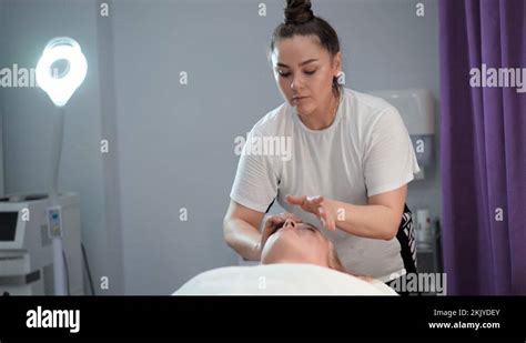 woman masseur make face relaxing massage beautiful female client in beauty salon stock video