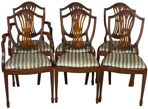 The four side chairs have a shield back design with shell, scroll, and acanthus leaf carvings. Set of six shield back dining room chairs. Hepplewhite ...