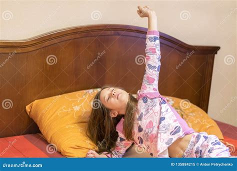 Cute Little Girl Stretching Her Arms Happily With A Smile From Waking