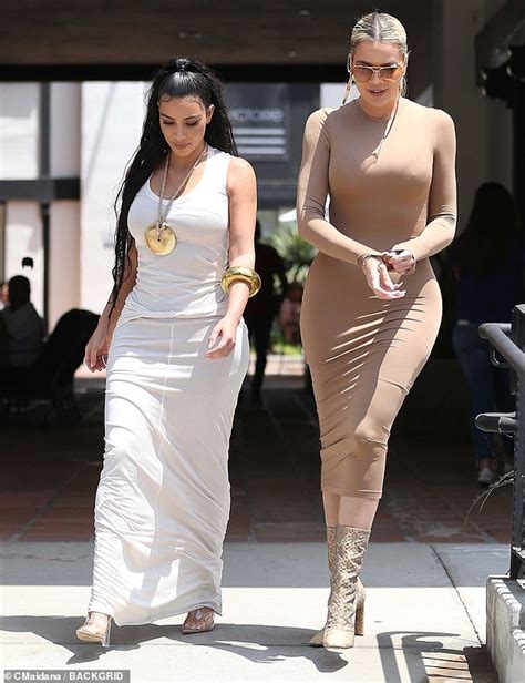 Kim Kardashian Shows Off Figure In A Skintight White Dress As She Steps