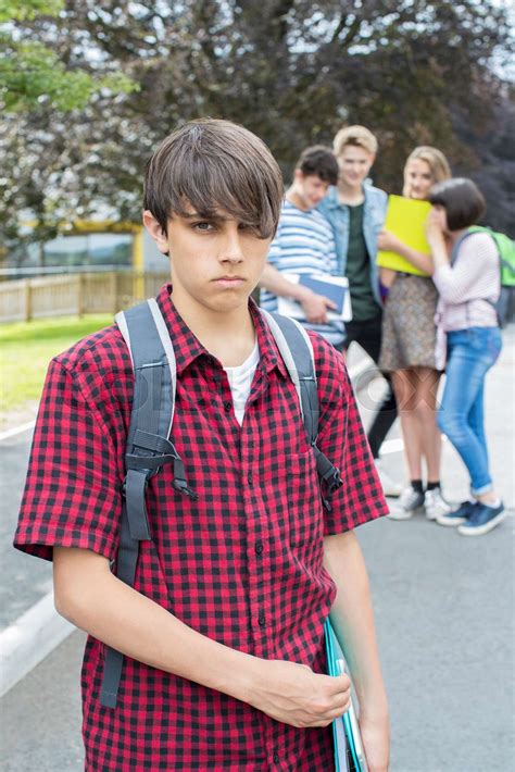 Unhappy Boy Being Gossiped About By School Friends Stock Image