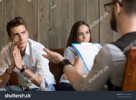 Frustrated Young Man Listening Psychologist While Stock Photo