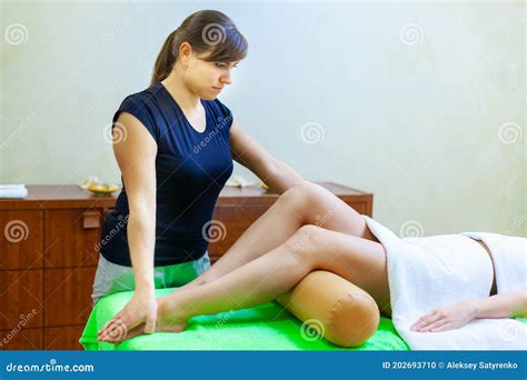 Side View Of Professional Massage Therapist Giving Massage On Woman