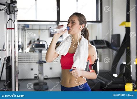 Portrait Of A Woman At The Gym Drinking Water Stock Image Image Of
