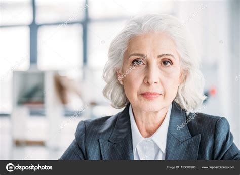 Senior Businesswoman At Workplace — Stock Photo © Igortishenko 153608288