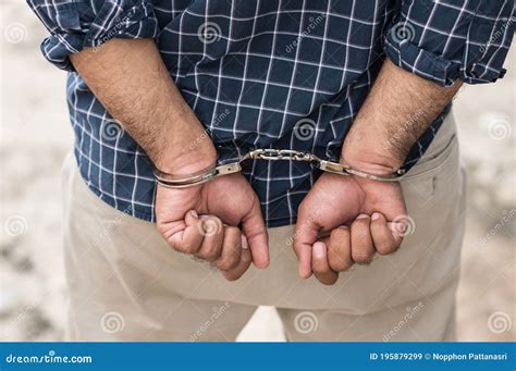 Prisoner Man In Jail With Handcuffs Close Up Shackled In Hands Stock