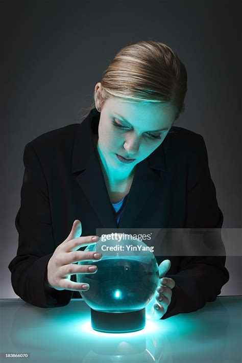 Business Person Looking Into Crystal Ball To Forecast The Future High