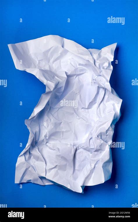 Wrinkled White Piece Of Paper Over A Blue Background Stock Photo Alamy