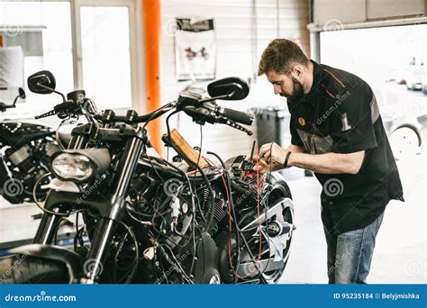 Professional Motorcycle Mechanic Working In Bike Repair Service Stock