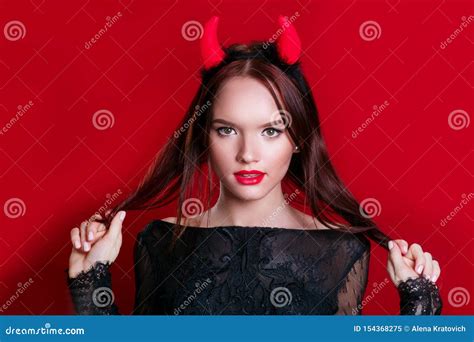 Sensual Caucasian Young Woman With Medium Brunette Hair In Devil Halloween Costume Stock Image