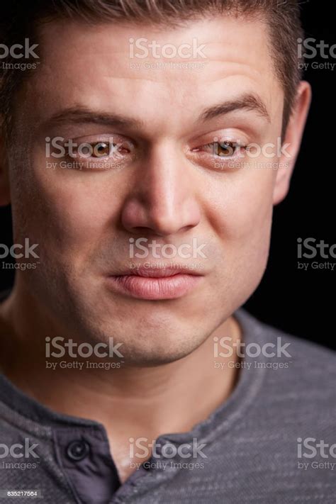 Vertical Portrait Of Crying Young White Man Looking Down Stock Photo