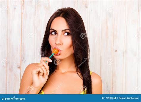 Portrait Of Beautiful Young Girl Licking Chupa Chups Stock Photo