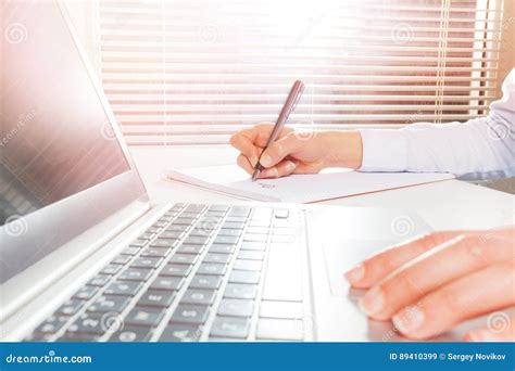 Woman S Hands Using Laptop And Writing On Notepad Stock Image Image