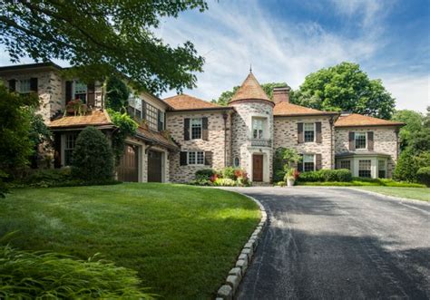 A Large Stone House With A Driveway Leading To It