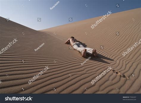Man Lying Between Desert Sand Dunes Stock Photo 77392207 Shutterstock