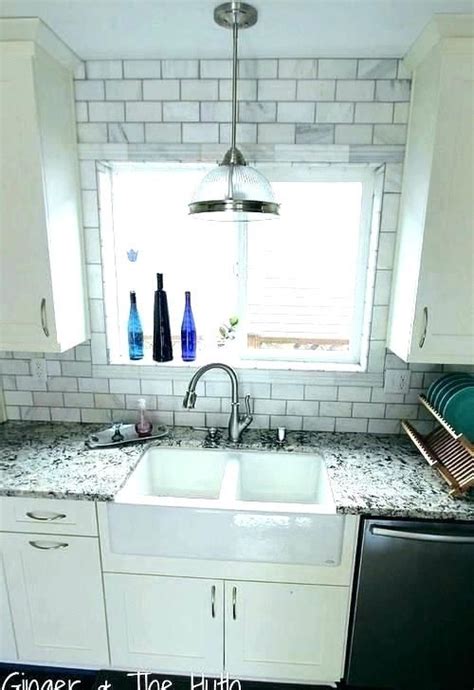 Or, do a larger trim so you eliminate that odd sliver, and stop at bottom of cabinets. subway tile around window window subway tile around window ...