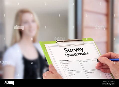 Girl Answering Market Research Survey Questionnaire At The Door Stock