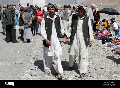 Afghan men wearing traditional clothes, transborder market near