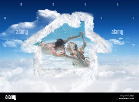 Cute Couple Kissing Underwater In The Swimming Pool Against Bright Blue Sky With Clouds Stock