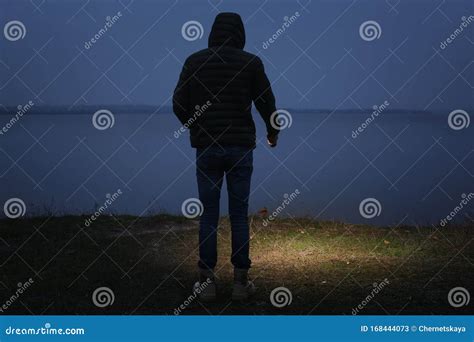 Man With Flashlight Walking Near River Stock Image Image Of Outdoors