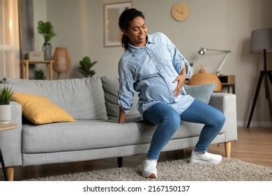 Pregnant Black Female Standing Sofa Touching Stock Photo Shutterstock