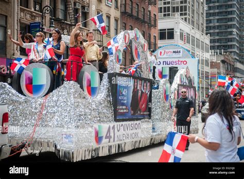 celebrities from television network univision ride on their float in the 33rd annual dominican