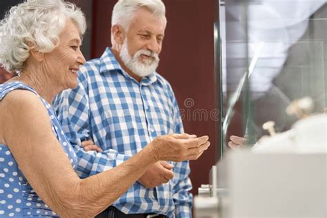 Smiling Senior Woman With Her Husband In Jewelry Store Stock Photo