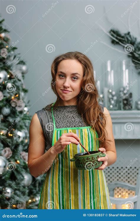 Beautiful Girl In A Kitchen Apron With Spoon And Bowl In A Hands Stock Image Image Of Smiling