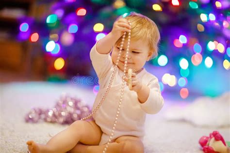 Adorable Baby Girl Holding Colorful Lights Garland In Cute Hands