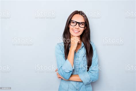 Young Thoughtful Secretary In Glasses Dreaming On Gray Background Stock