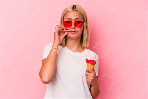 Premium Photo Young Venezuelan Woman Eating An Ice Cream Isolated On Pink Background With