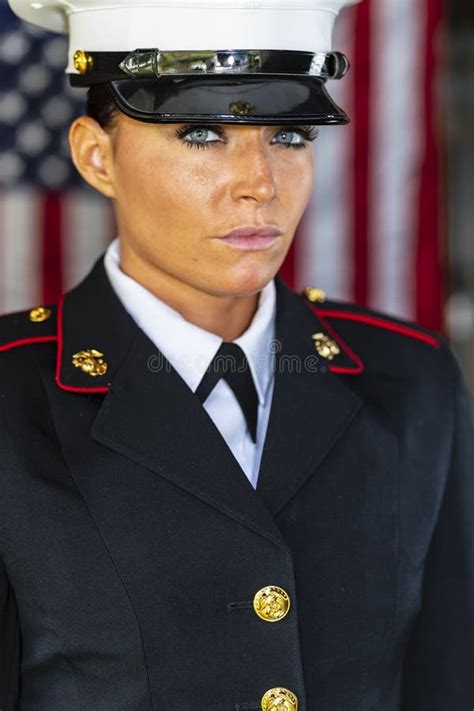 A United States Female Marine Posing In A Military Uniform Stock Photo