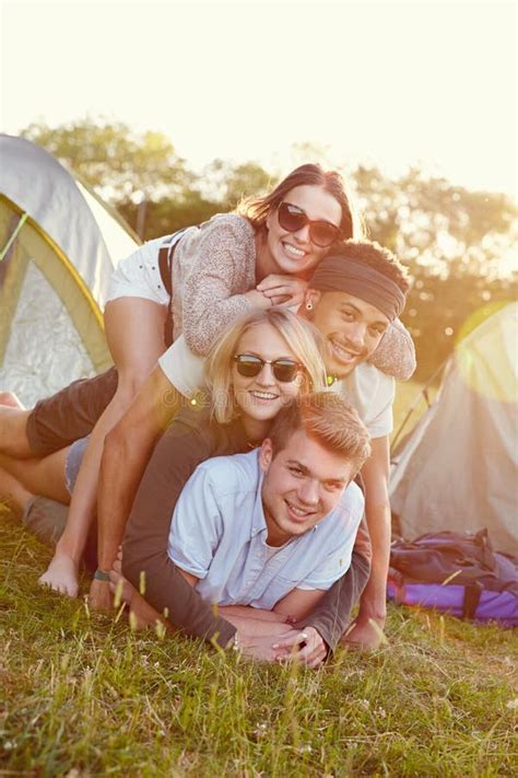 Group Of Friends Having Fun Outside Tents On Camping Holiday Stock