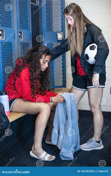 Two Soccer Teammates In A Locker Room Console Each Other After A Loss
