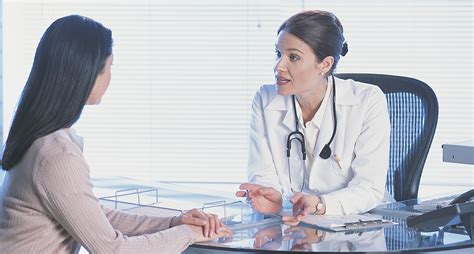 Doctor Consulting With Patient Cos
