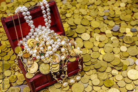 Vintage Treasure Chest Full Of Gold Coins And Jewelry On A Background