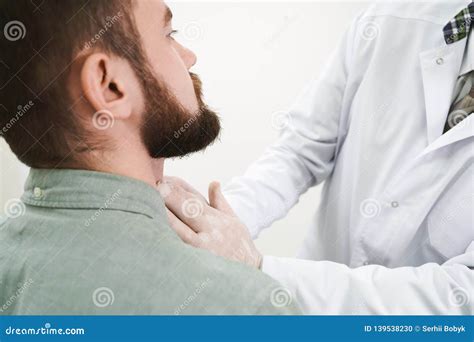 Bearded Man On Lymph Nodes Examination In Doctor Stock Photo Image